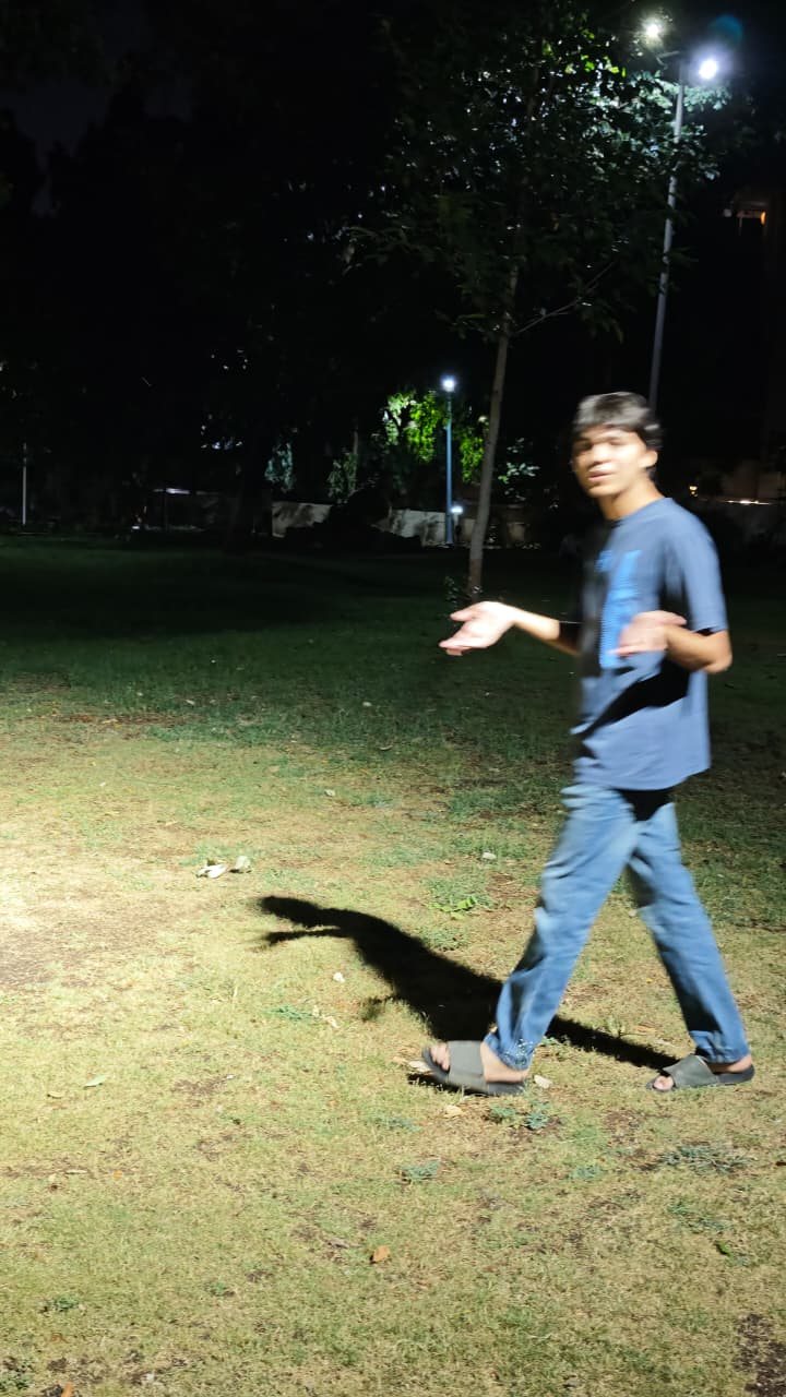 Chaitanya walking across grass at night