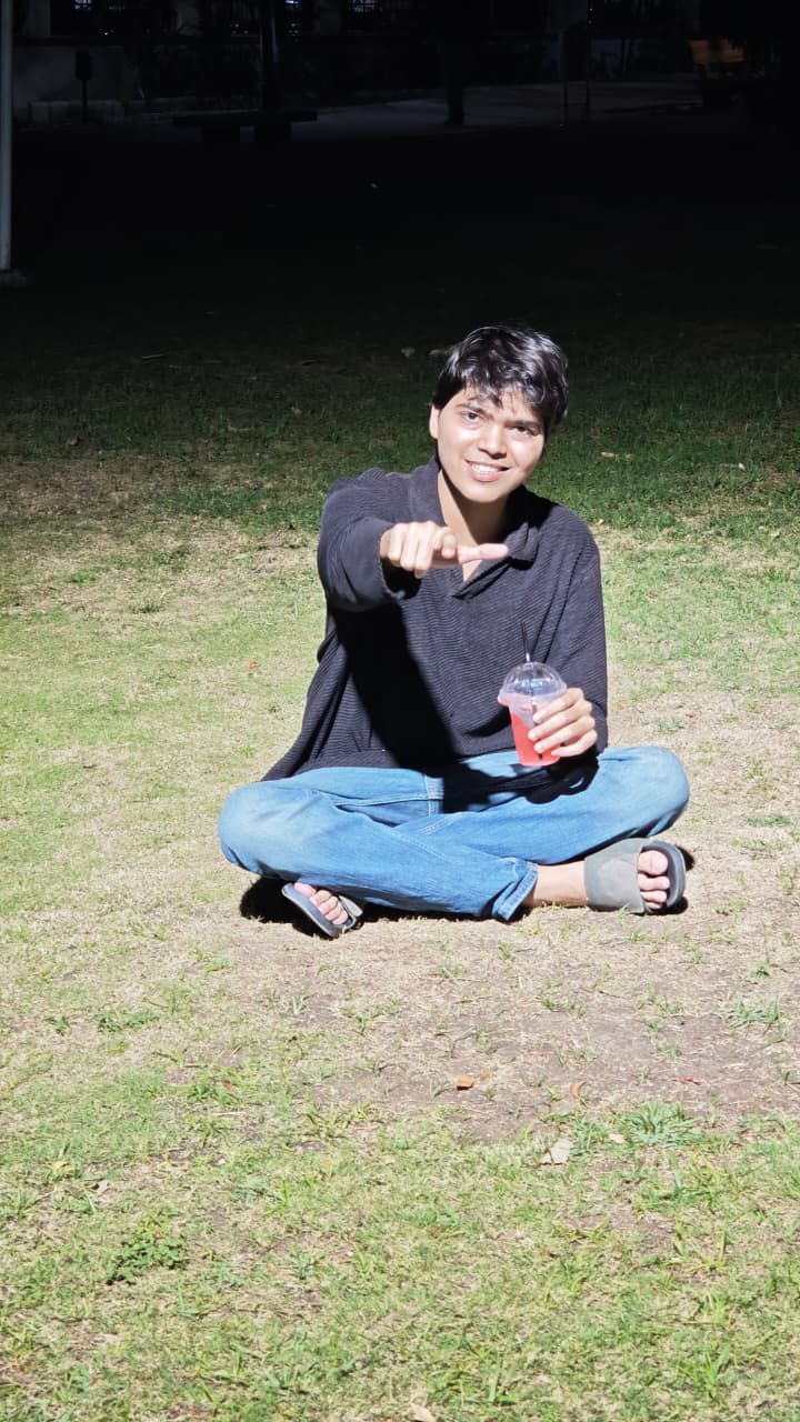 Chaitanya seated and looking toward camera