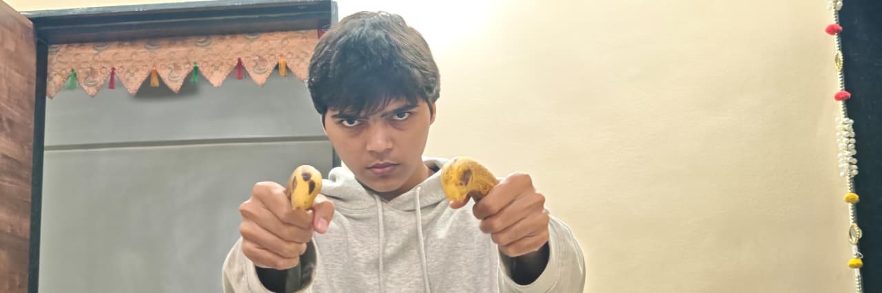 Chaitanya holding fruit indoors