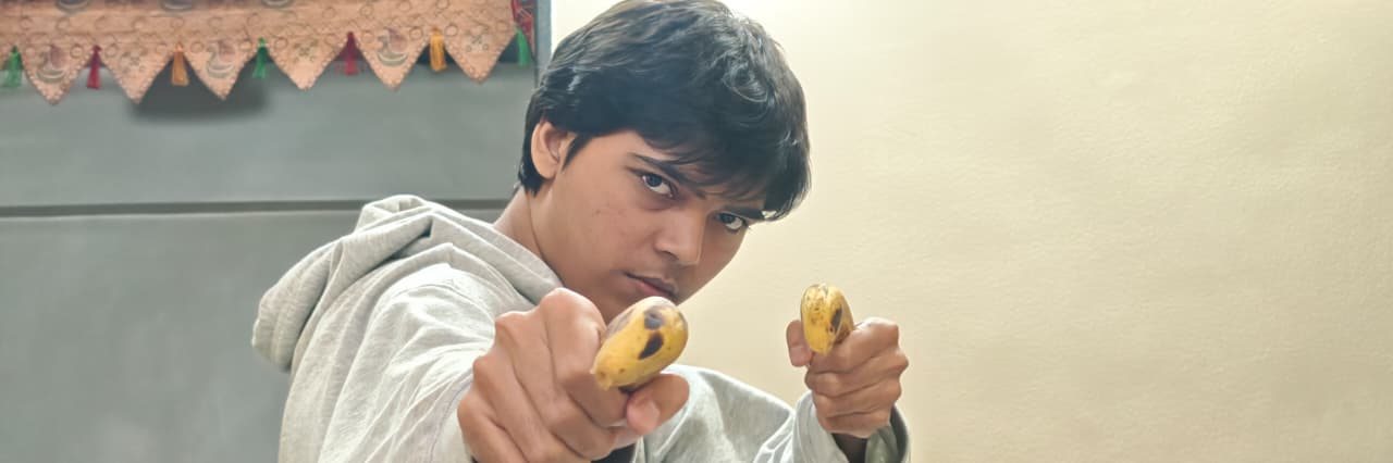 Chaitanya holding fruit indoors